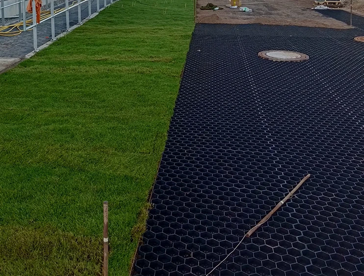 Laying new turf rolls for lawn renewal.